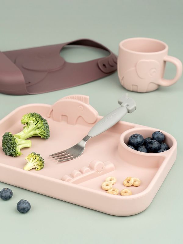 Done by Deer a cute food silicone handle mug stays in the hand of a very small child and is easy to drink.
