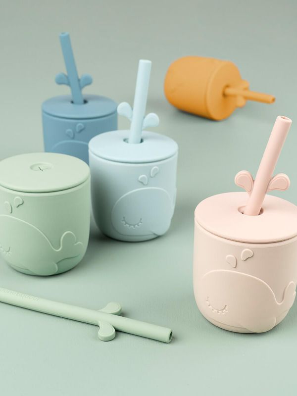 Done by Deer a cute food silicone straw cup stays in the hand of a very small child and is easy to drink.