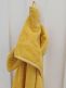 Light-colored hooded towel for babies to shower and bath tubs moments.