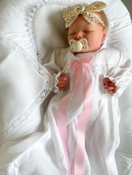 Linen christening cloth. The priest is supposed to use the cloth to dry the baby's head after the baptism.