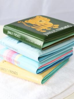 A colorful A Little Lovely Company bath book for baby's moments of joy.