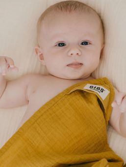 BIBS Muslin cloth is premium GOTS certified multifunctional baby cloth that can be used as a burp cloth, nursing cover, a cover on your changing mat, or as a bib.